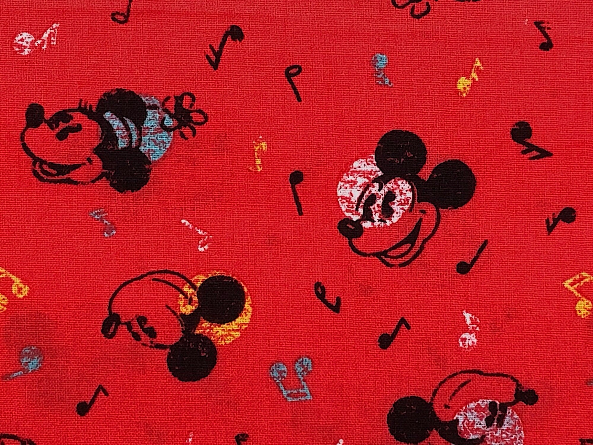Close up of mickey mouse and music notes.