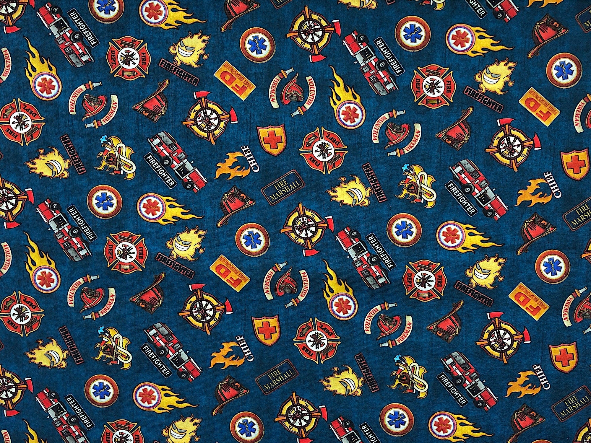This fabric is covered with firefighter shields. This fabric is part of the 5 Alarm collection