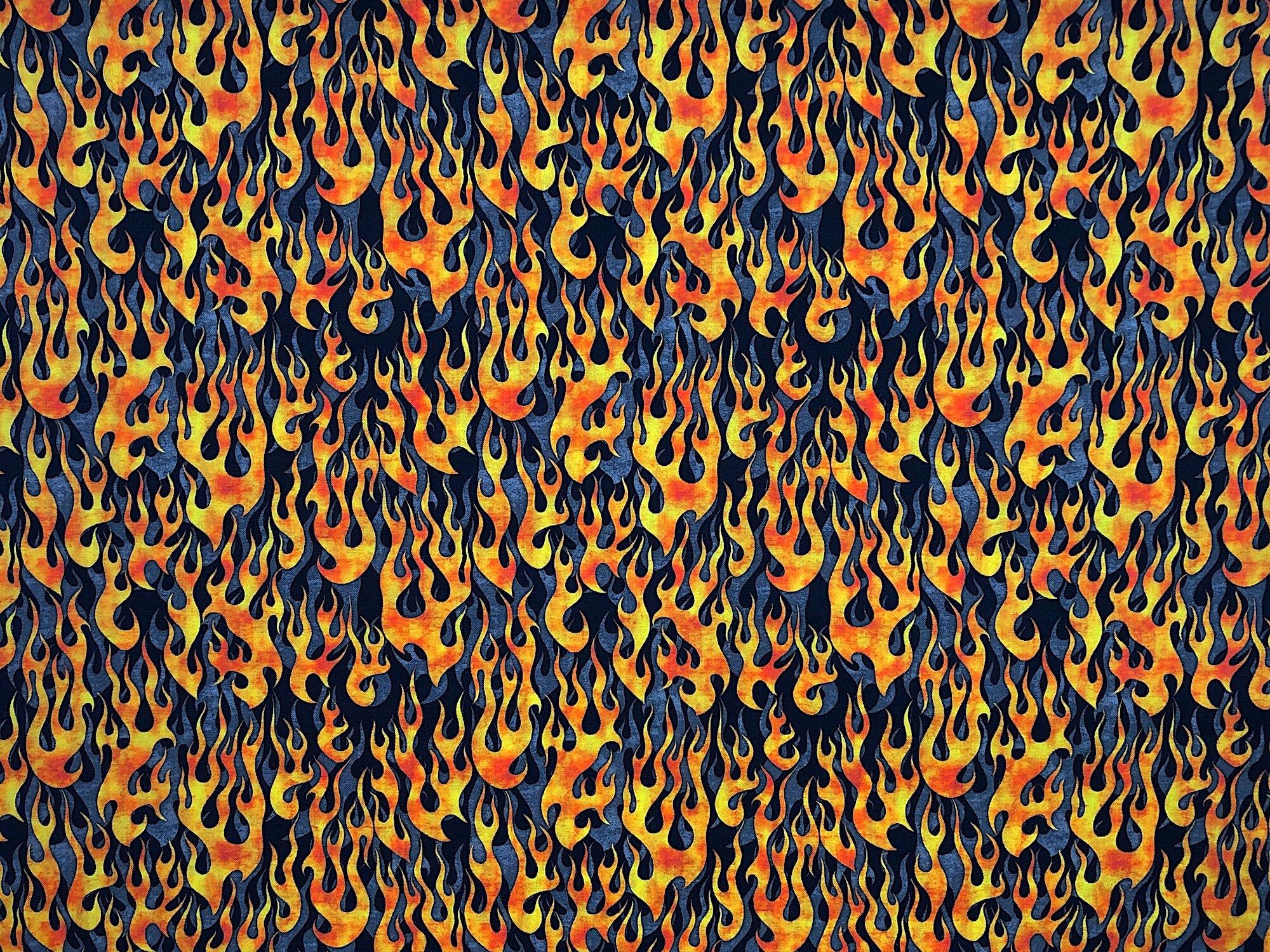 This black and gray fabric is part of the 5 Alarm collection and is covered with flames.