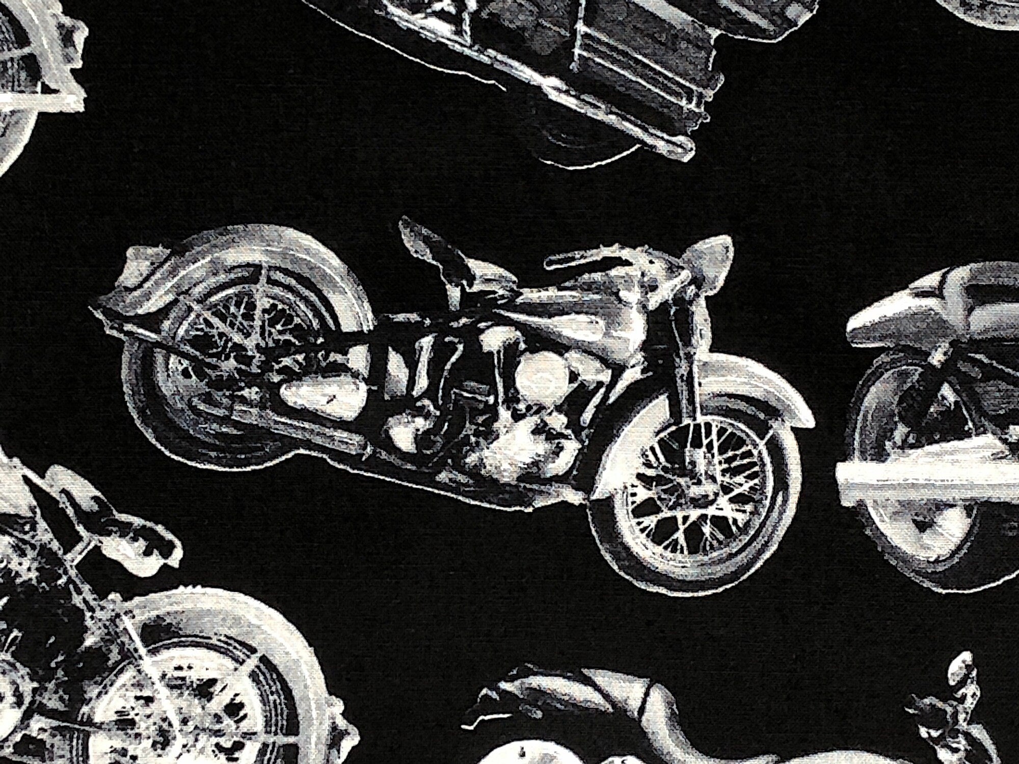 Close up of a motorbike on a black background.
