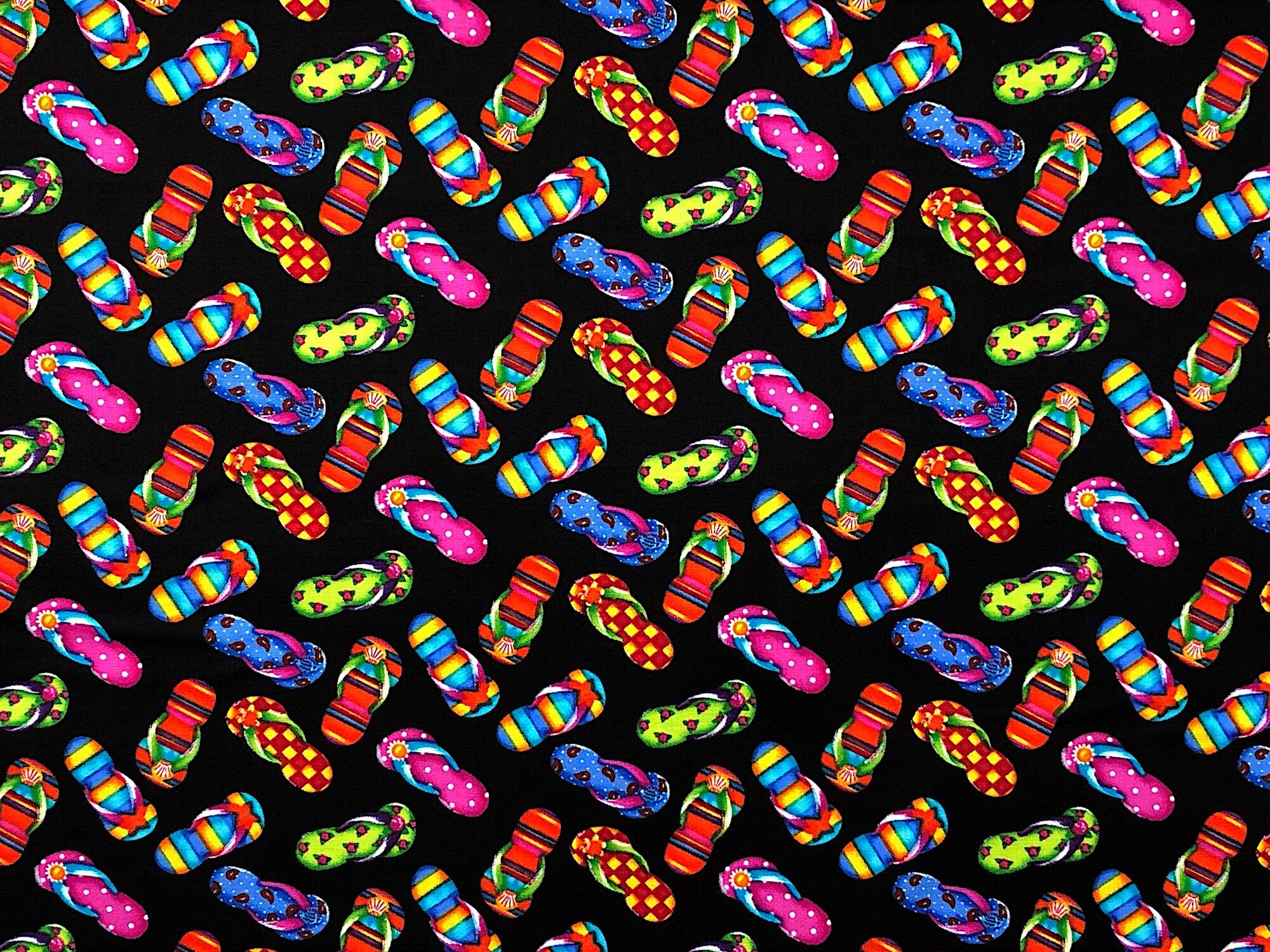 This pretty summer fabric is covered with flip flops that are yellow, orange, red, green, blue and pink. The background is black.