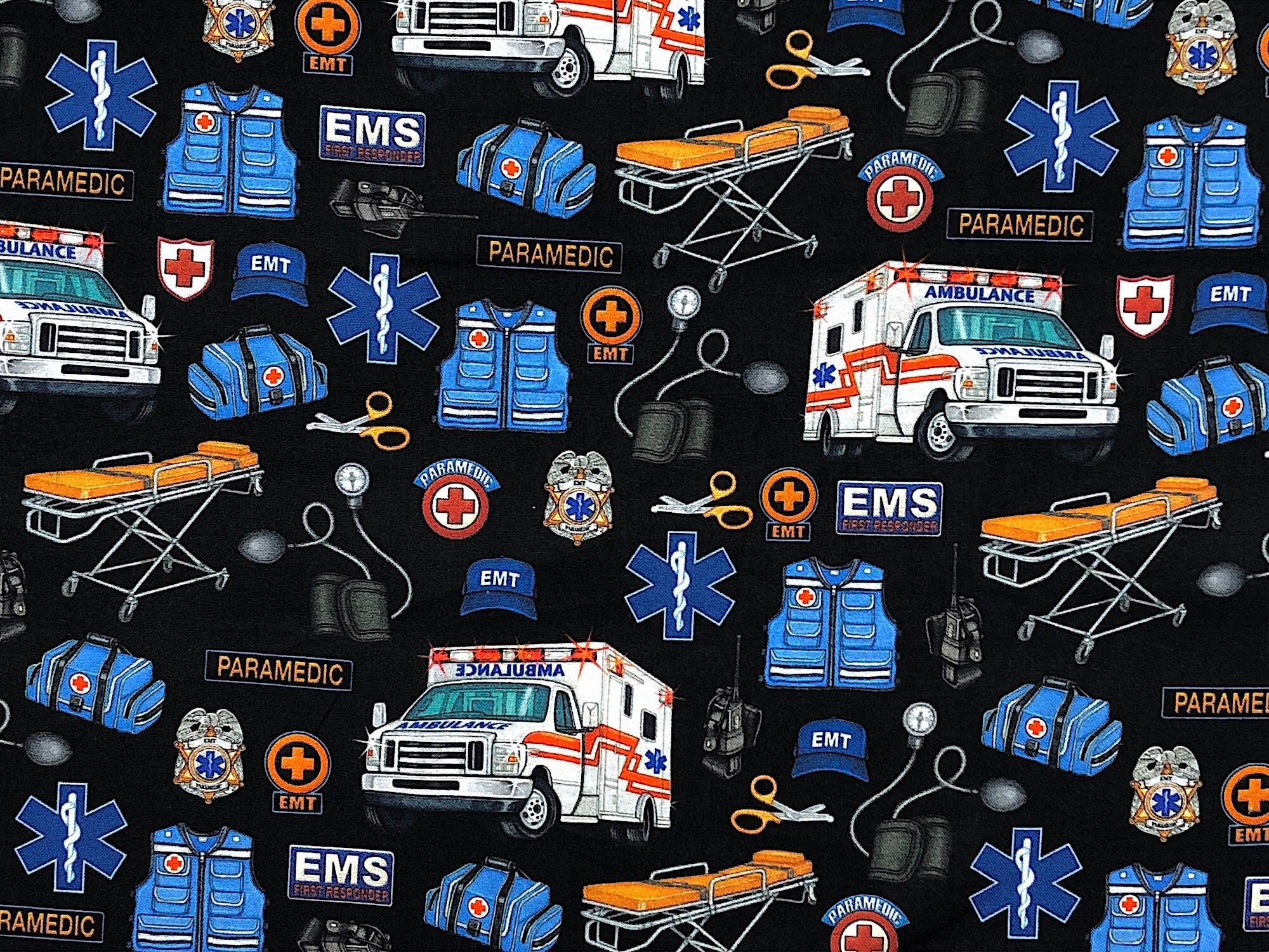 Black cotton fabric covered with ambulances, stretchers and paramedic equipment