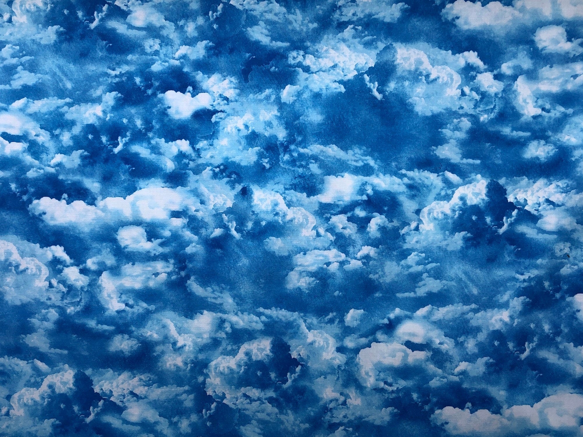 This fabric is covered with blue and white clouds.