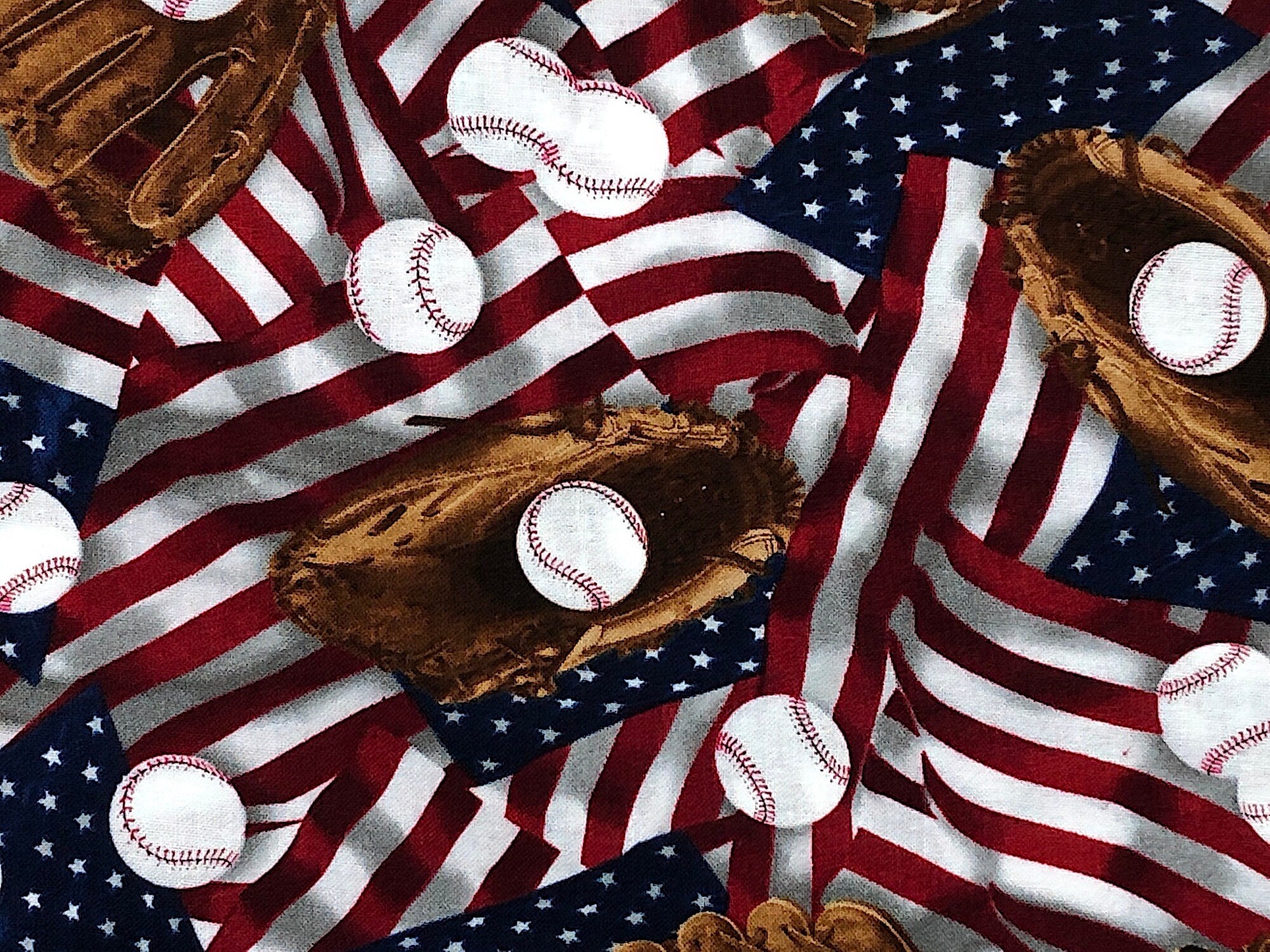 Close up of baseball mitts, gloves and USA flags.