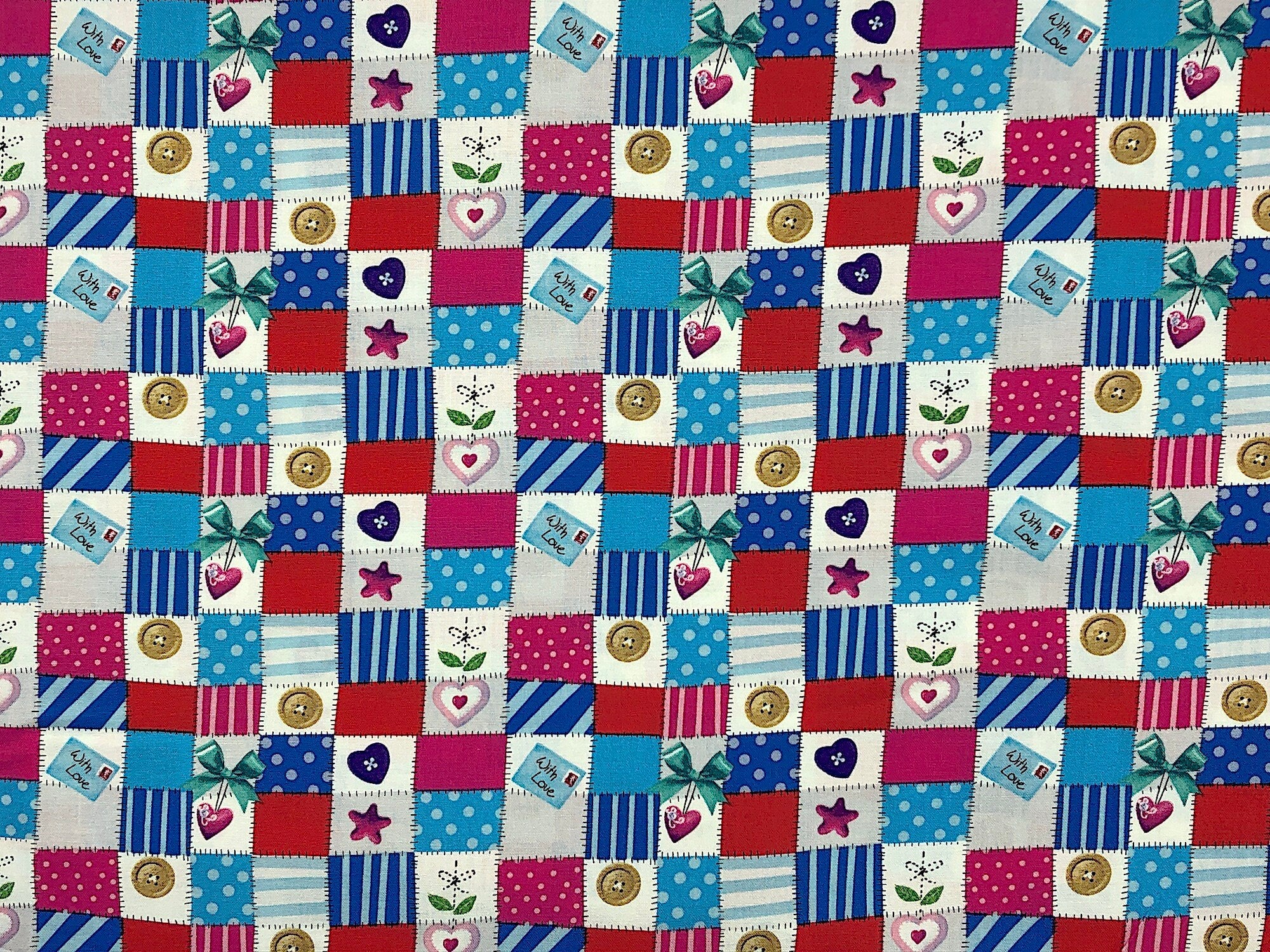 This fabric is called Mini Patchwork. It's covered with small squares of fabric that have been stitched together. Some of the patchwork squares have hearts, buttons or bows on them This fabric is part of the big hugs collection.