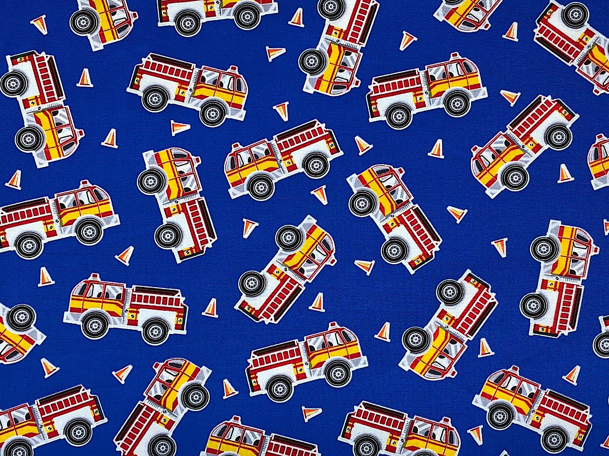 This fabric is called Fire Engines Blue and is covered with Fire Engines. The blue background also has orange cones scattered throughout