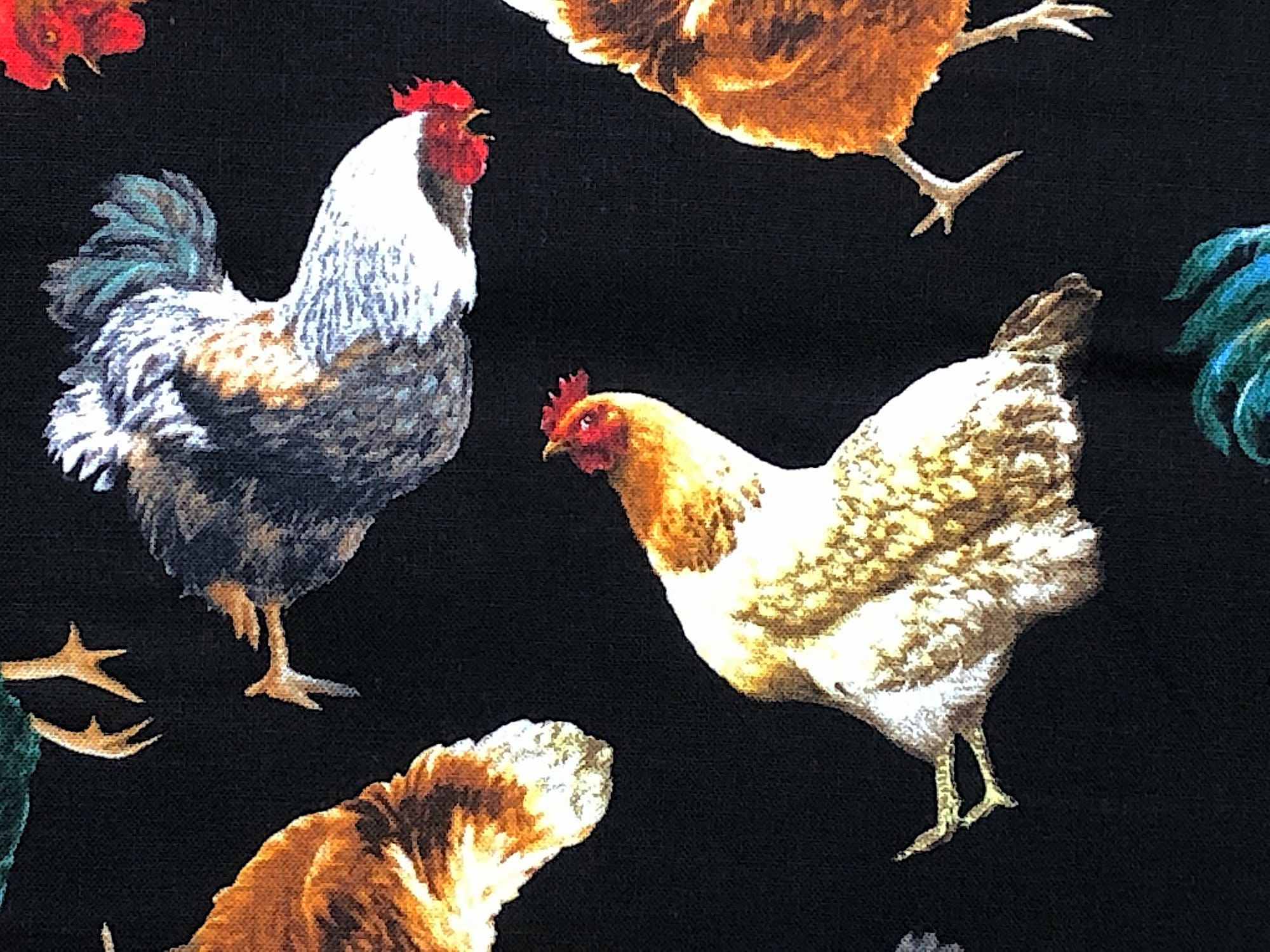 This fabric is called tossed chickens. This black fabric is covered with chickens that are white, cream, beige and brown.
