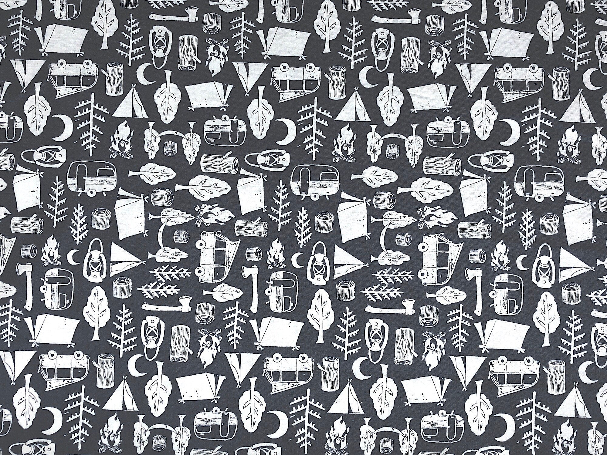 This fabric is covered with tents, trees, lanterns, travel trailers and more. This Midnight Camping fabric has a blue background.