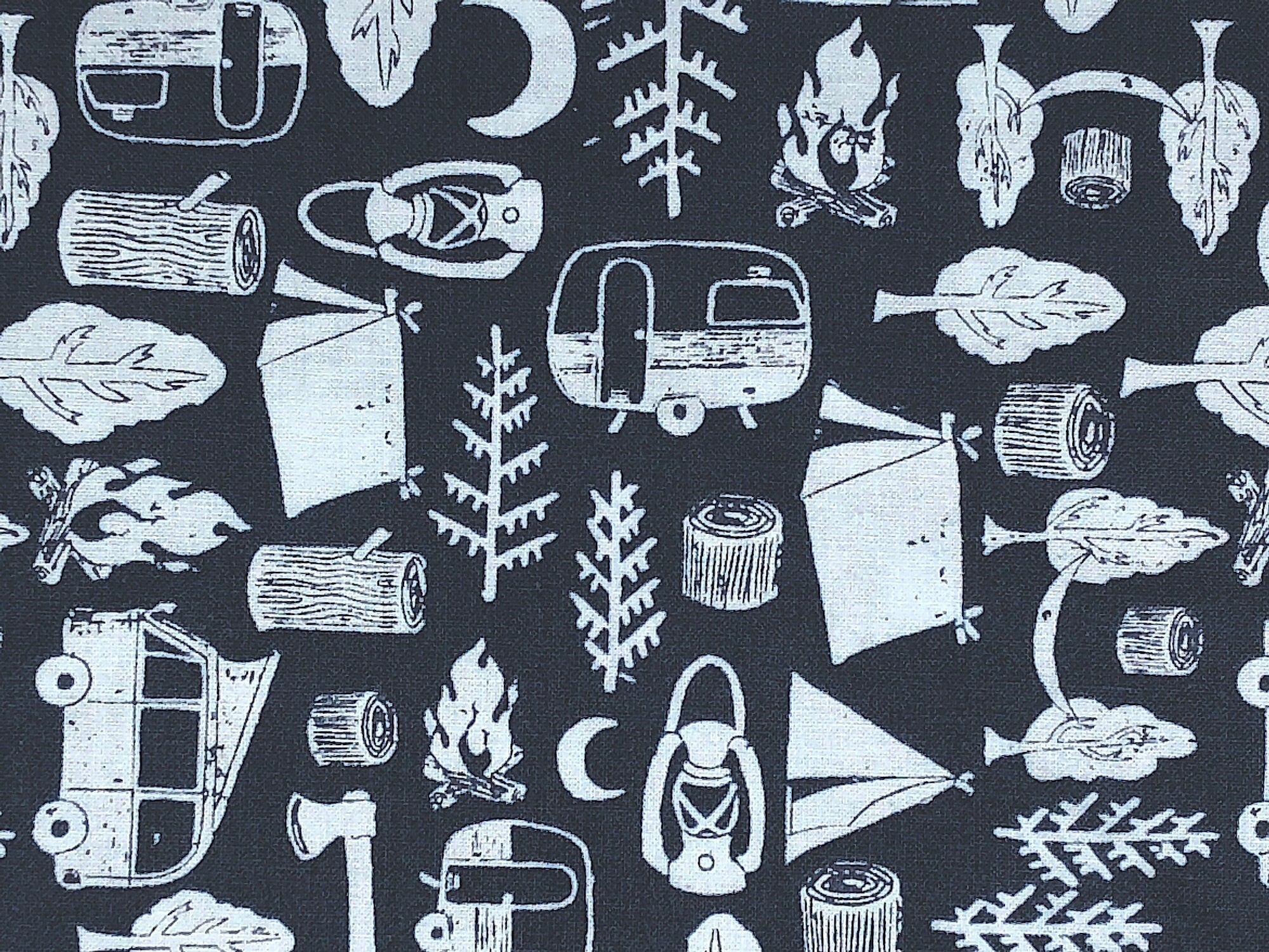 This fabric is covered with tents, trees, lanterns, travel trailers and more. This Midnight Camping fabric has a blue background.
