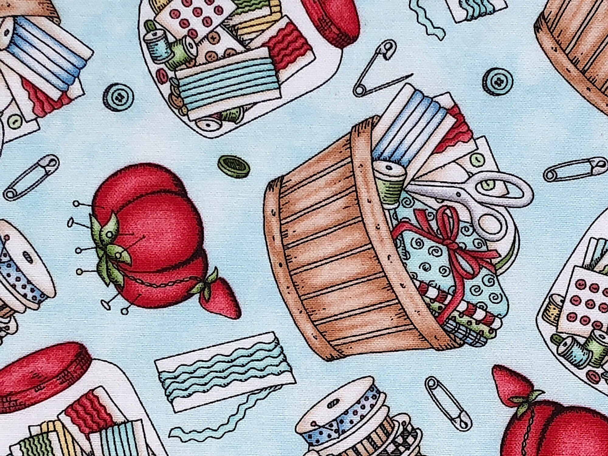 This fabric is covered with sewing notions such as buttons, thread, scissors, pincushions, fabric and more. There are also baskets and jars filled with sewing notions. 