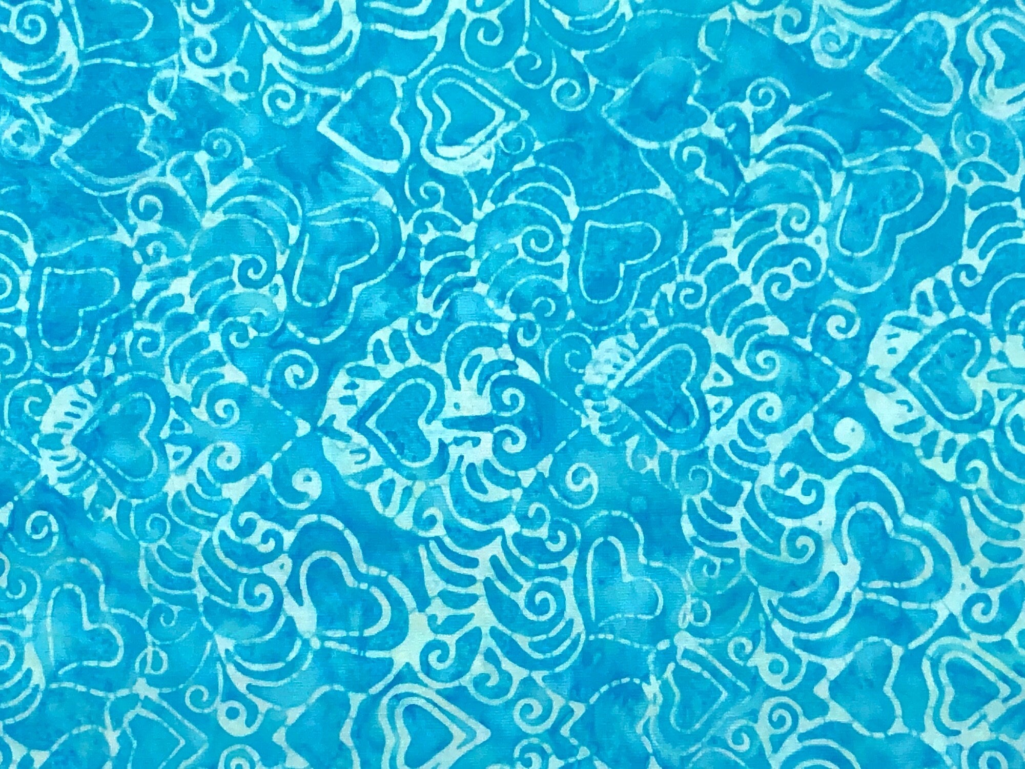 This fabric is part of the Love & Kisses Collection and is covered with hearts. This turquoise batik fabric is called Funky 70's waterfall.