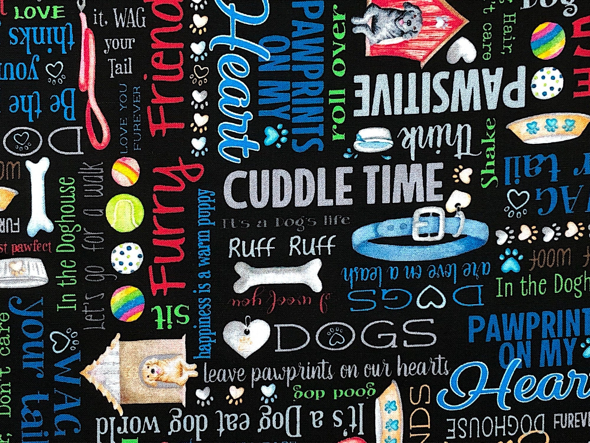 This black fabric is covered with dog sayings such as wag your tail, fetch, life of the dog, hot diggity dog, furry and more.