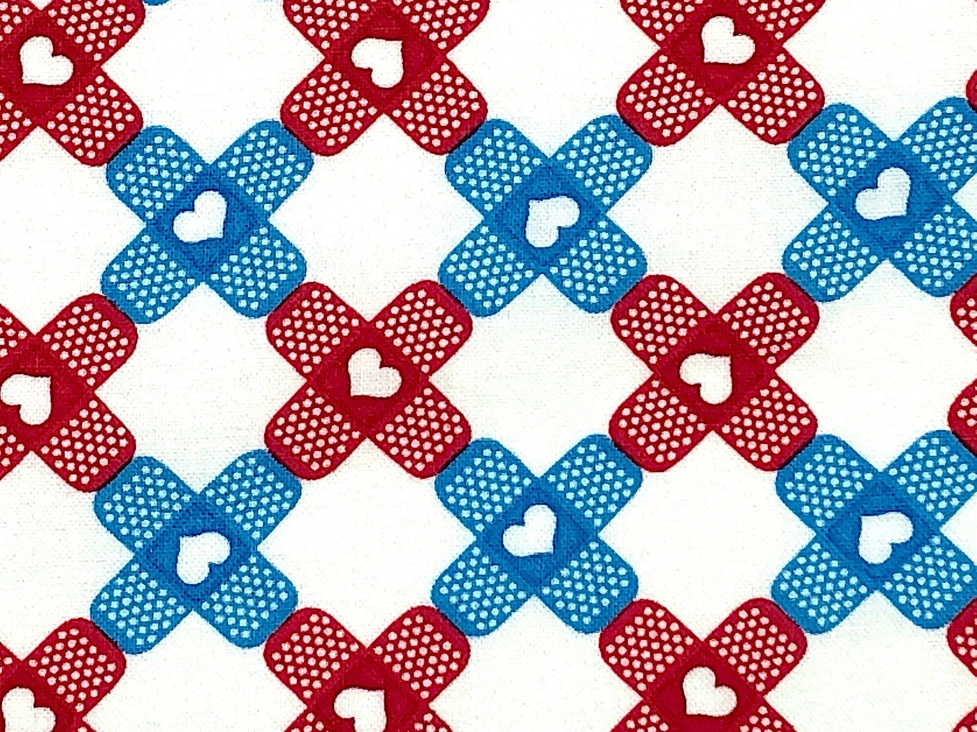 Close up of blue and red band aids on a white background.
