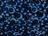 Close up of blue moons and stars on a dark blue batik cotton fabric.