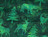 Close up of bear, deer and trees on green batik fabric.