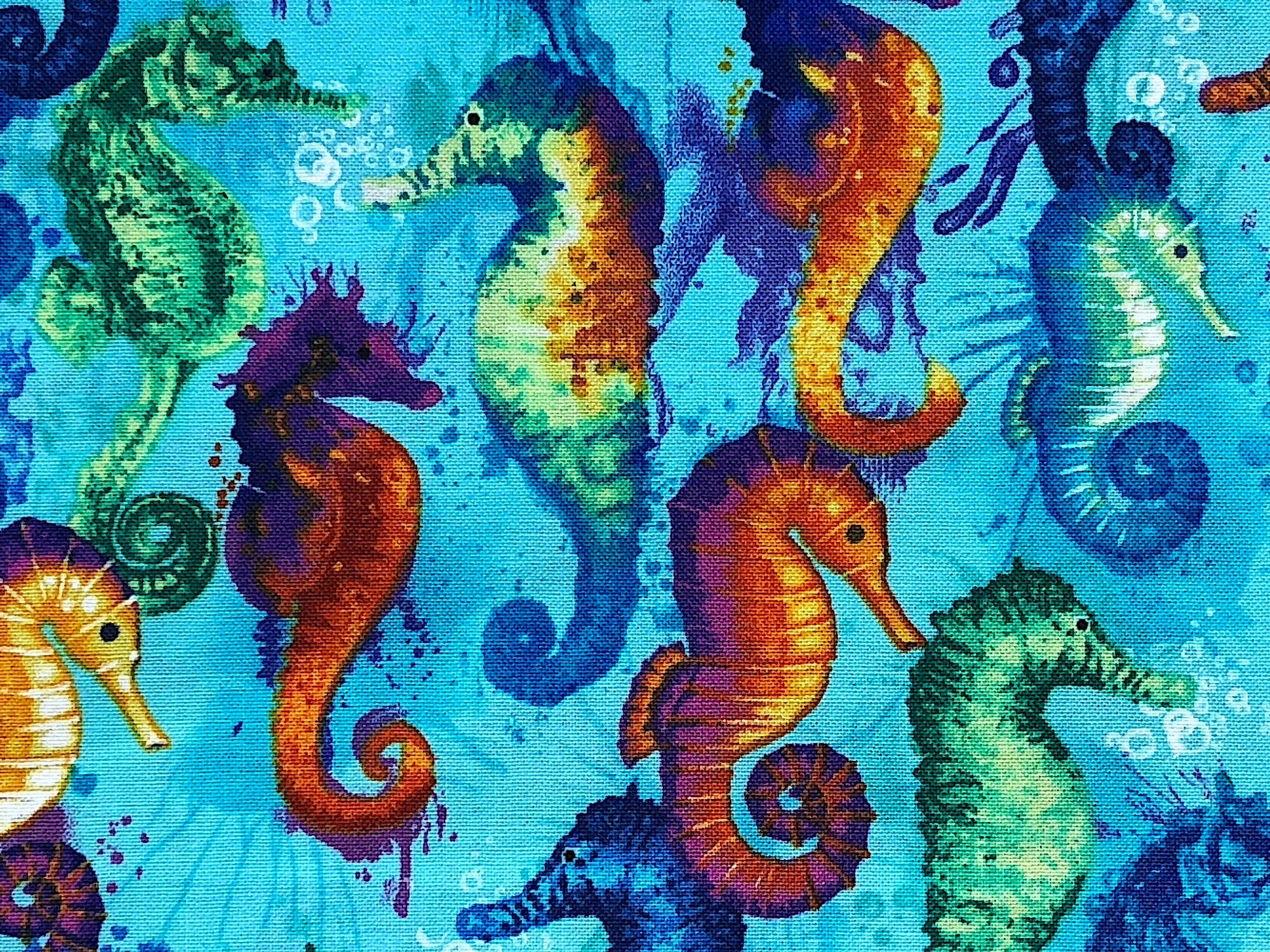 Close up of seahorses that are green, blue, yellow, red and purple.