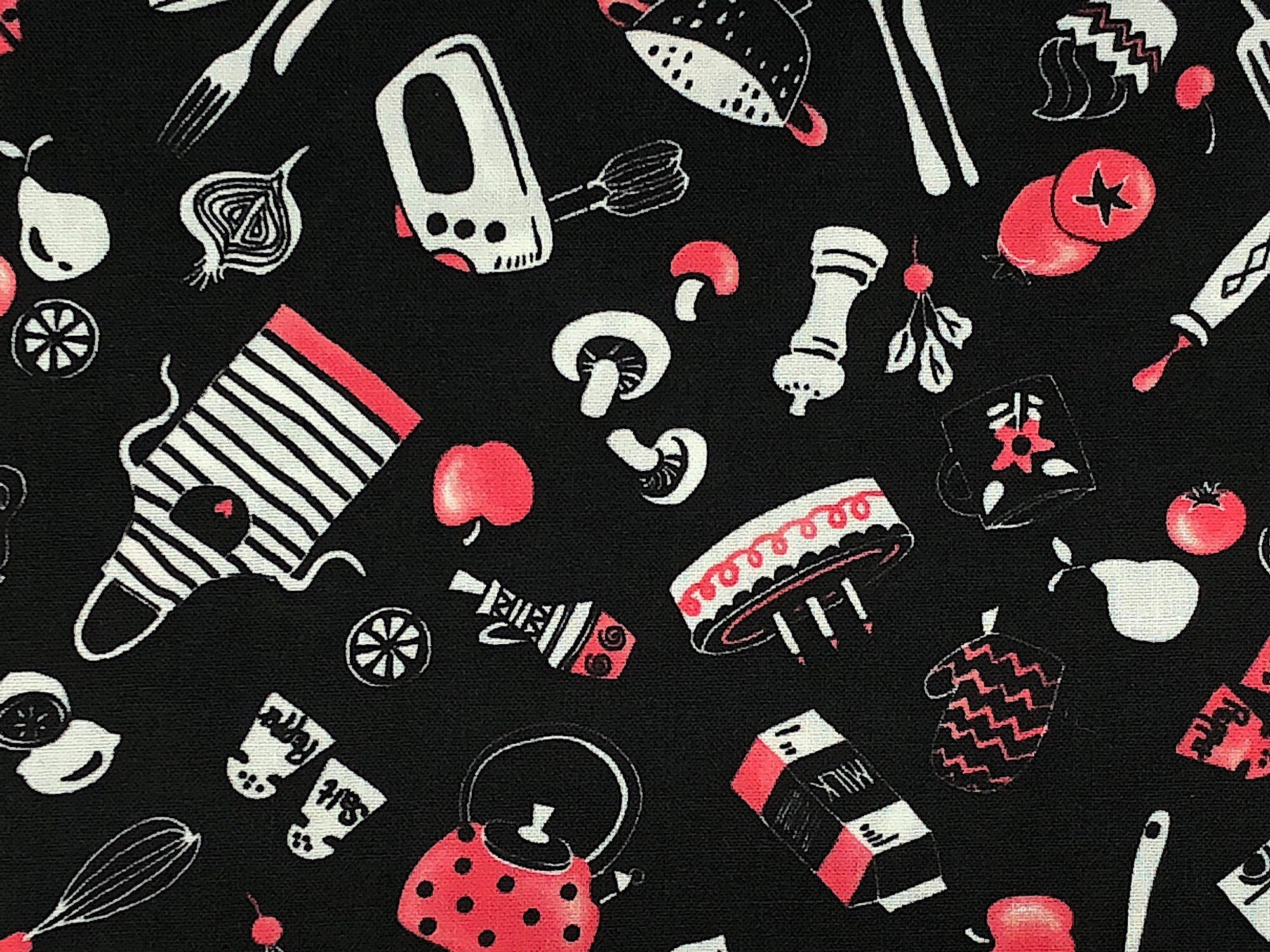 Close up of black fabric covered with food and kitchen items.