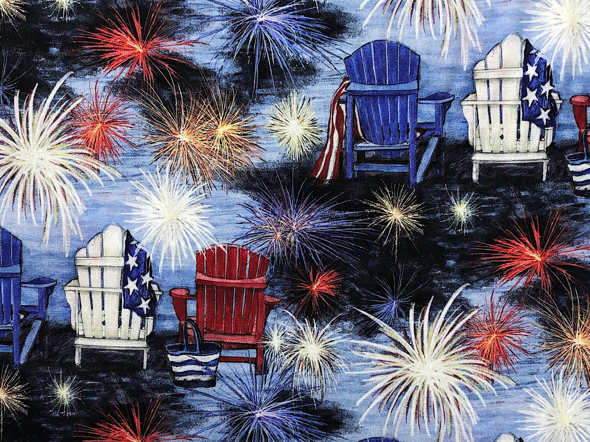 Close up of red, white and blue chairs and fireworks.