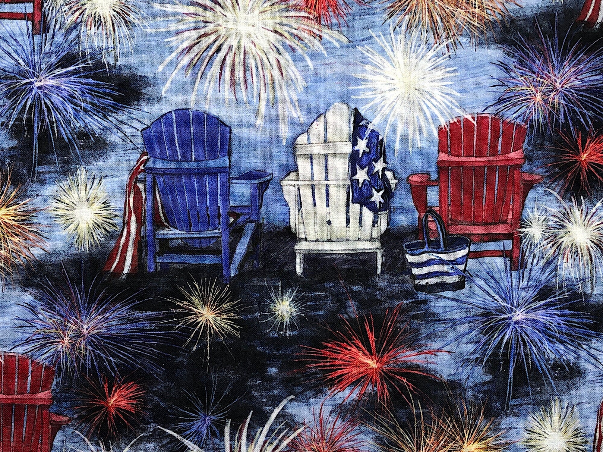 Close up of red, white and blue chairs and fireworks