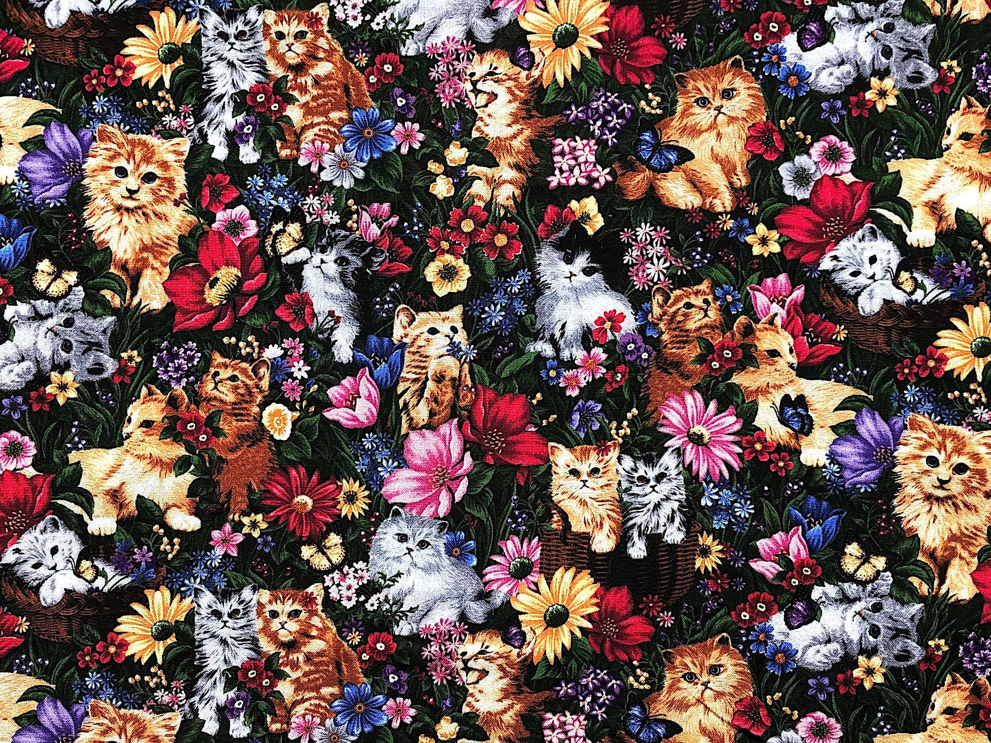 This fabric is covered with kittens, flowers and butterflies. The kittens are grey and beige tones. You will find blue, pink ,yellow and red flowers and blue and yellow butterflies. This fabric is called Purr-Fect Kittens in Flowers