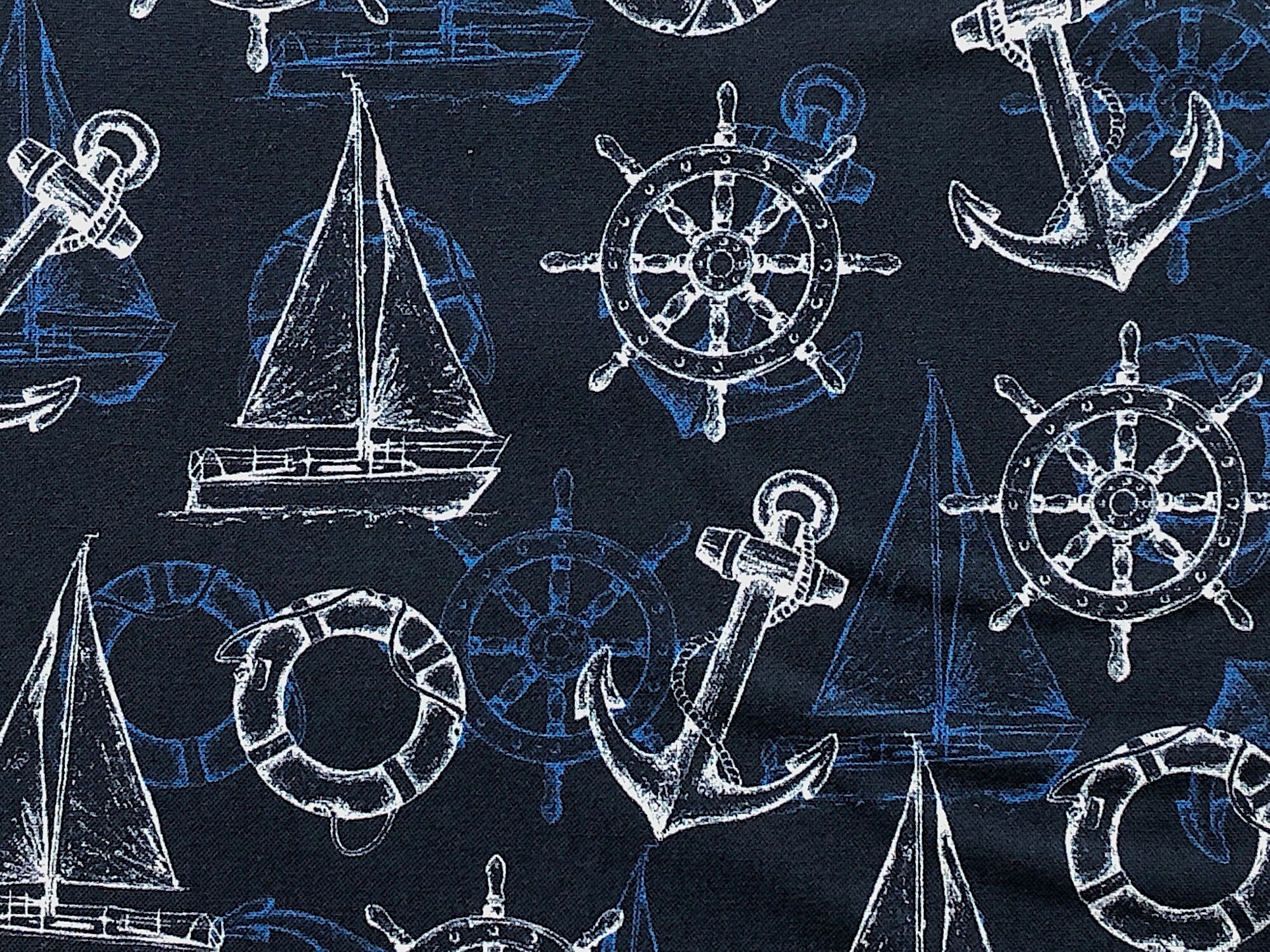Close up of sailboat, ships wheel and anchors.