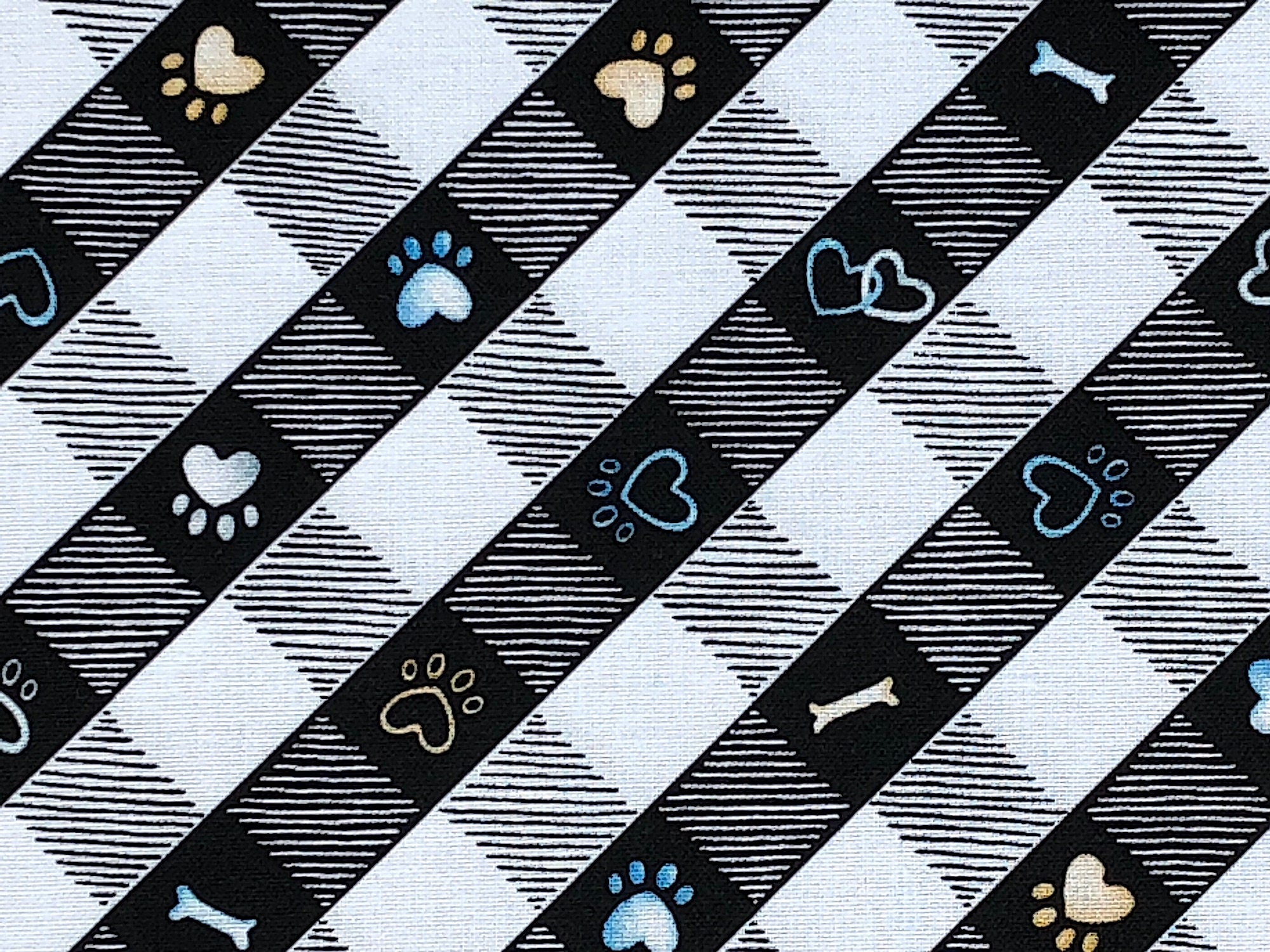 Close up of black and white checkered print , the black squares have paw prints or bones in them.