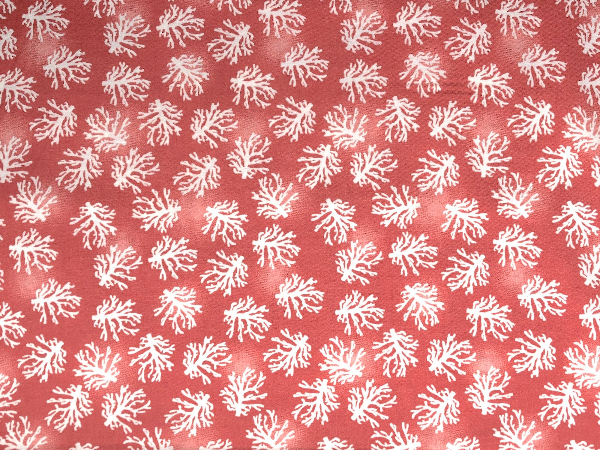 This nautical fabric is covered with coral. This fabric is part of the Beach Travel Collection by Beth Albert