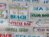 Close up of sayings such as welcome to the beach, oyster bar, shell shop and more.