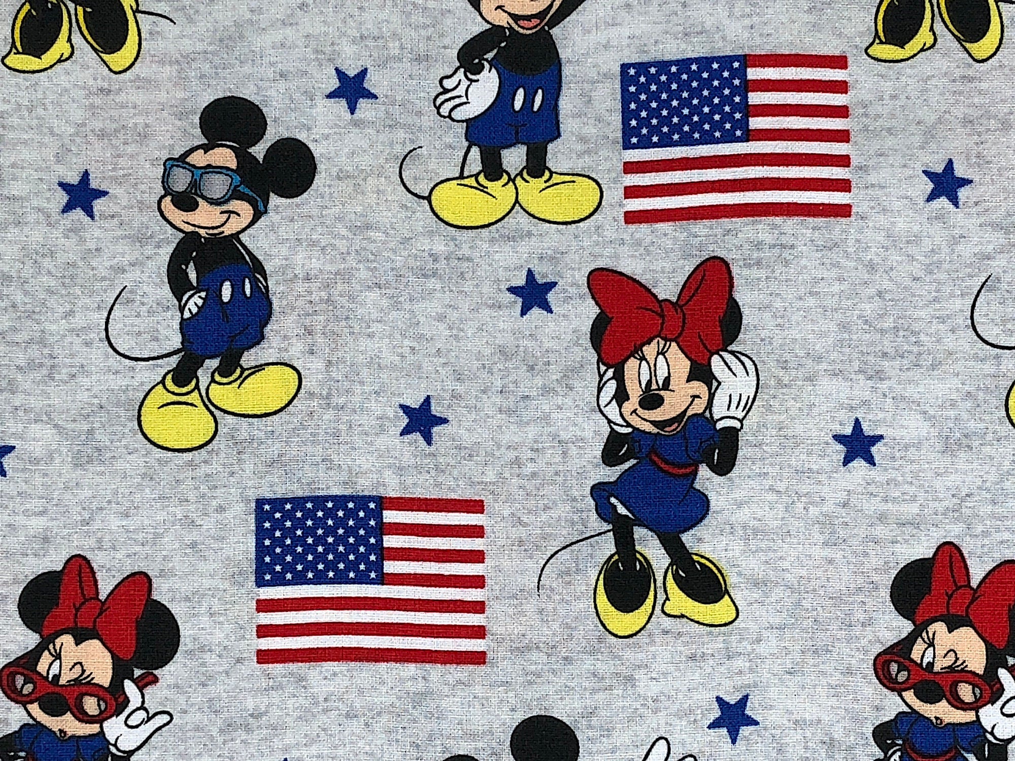 Close up of Mickey and Minnie Mouse and USA Flags.
