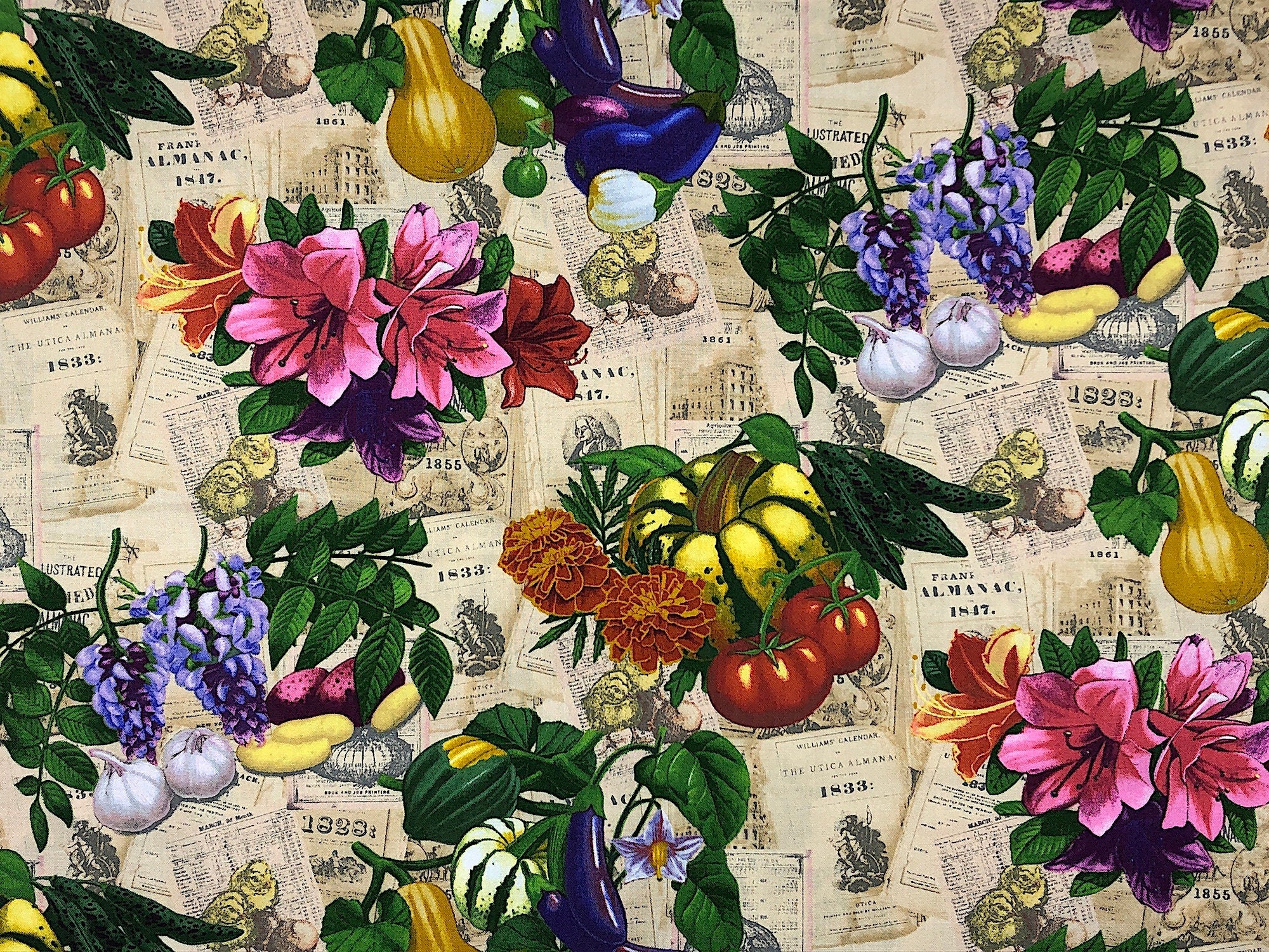 This fabric is covered with vegetables and flowers. In the background you will find the old farmers almanac. Some of the vegetables are tomatoes, squash and garlic. The flowers are lilies, marigolds and more.