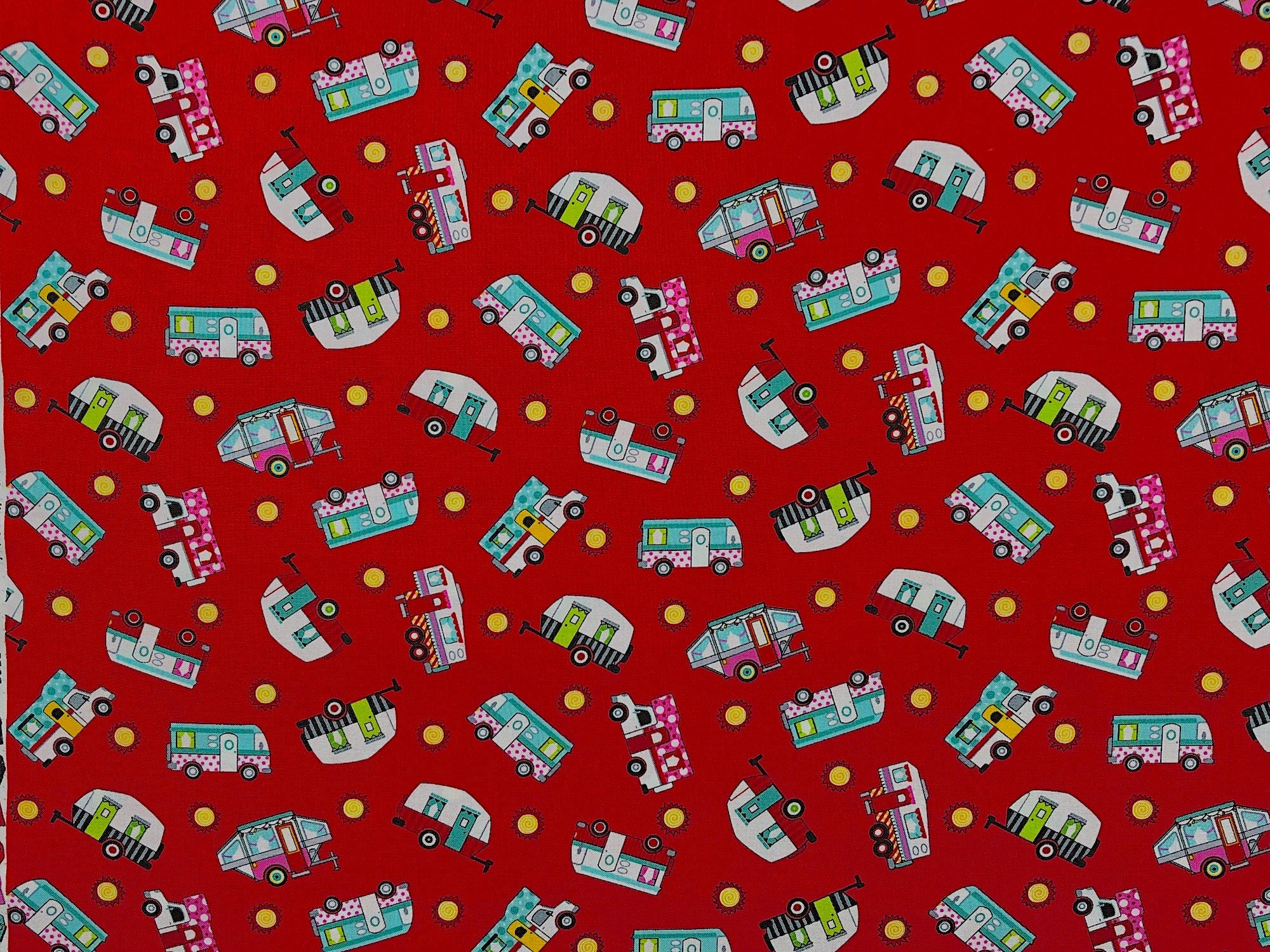 This fabric is called Tossed Campers Red and is covered with travel trailers, campers on trucks, 5th wheels and the sun