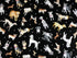 This black fabric is covered with dog breeds and small paw prints This fabric is part of the Think Pawsitive collection designed by Andi Metz.