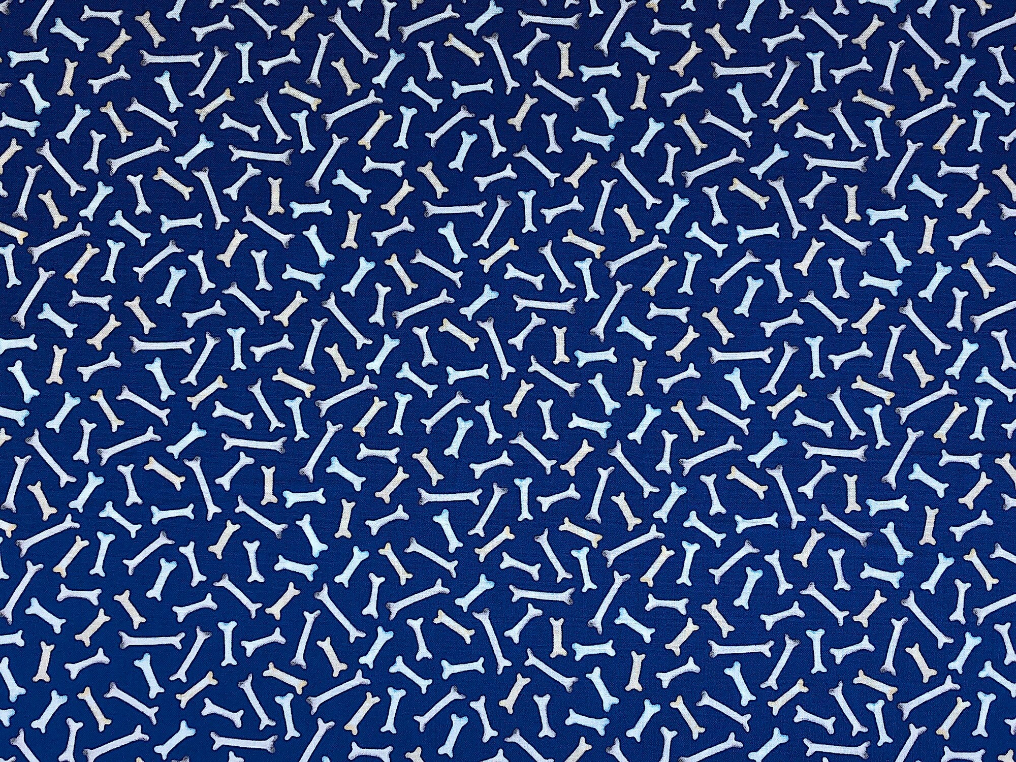 This fabric is part of the Think Pawsitive Collection by Andi Metz. This blue fabric is covered with dog bones.