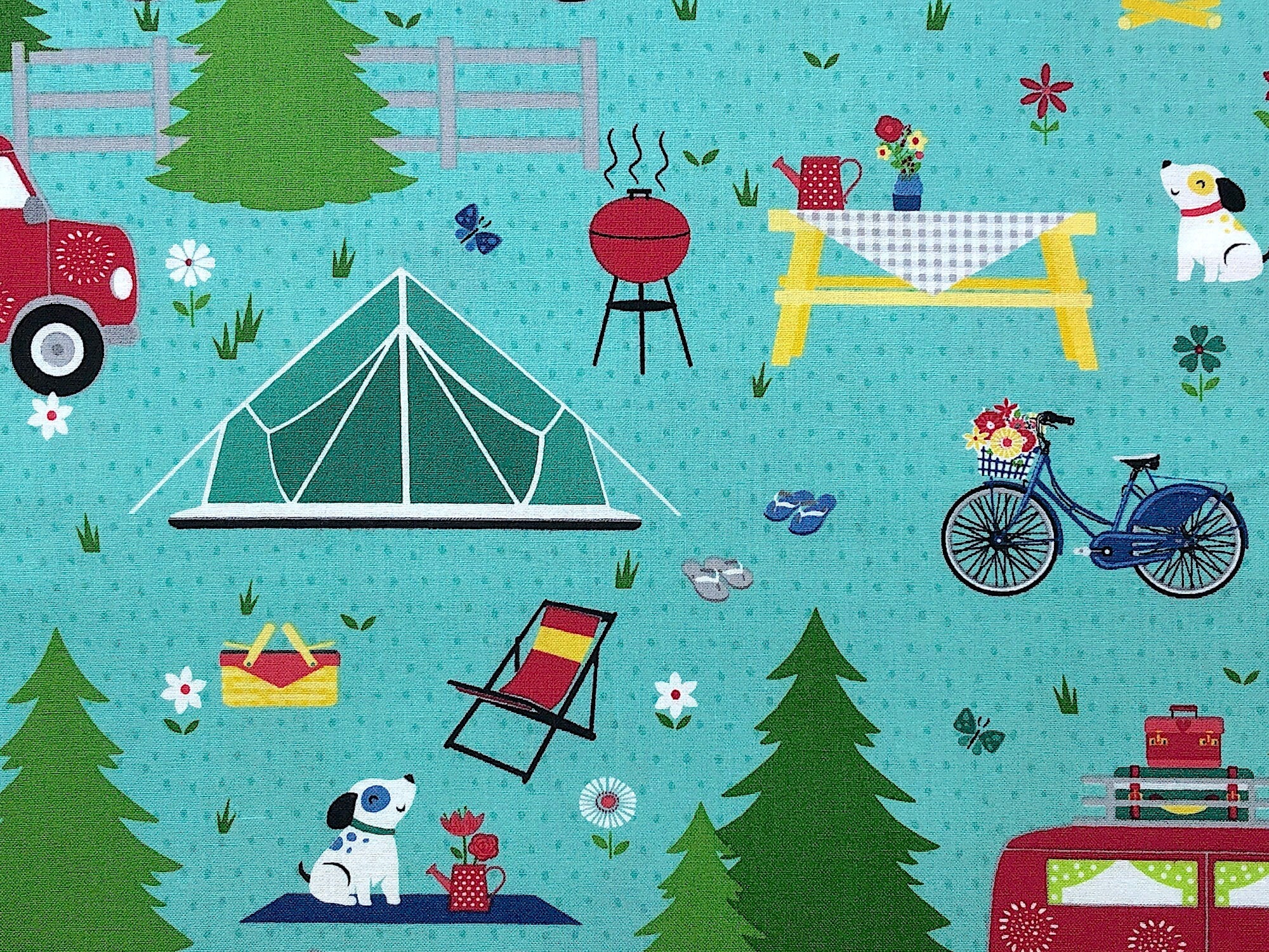 Close up of a camping scene with a tent, picnic table, bicycle, picnic basket, dog and more.