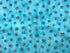 This digital print fabric is called Whiskers & Tails and is covered with shades of blue and brown paw prints. The background is in shades of blue/teal.