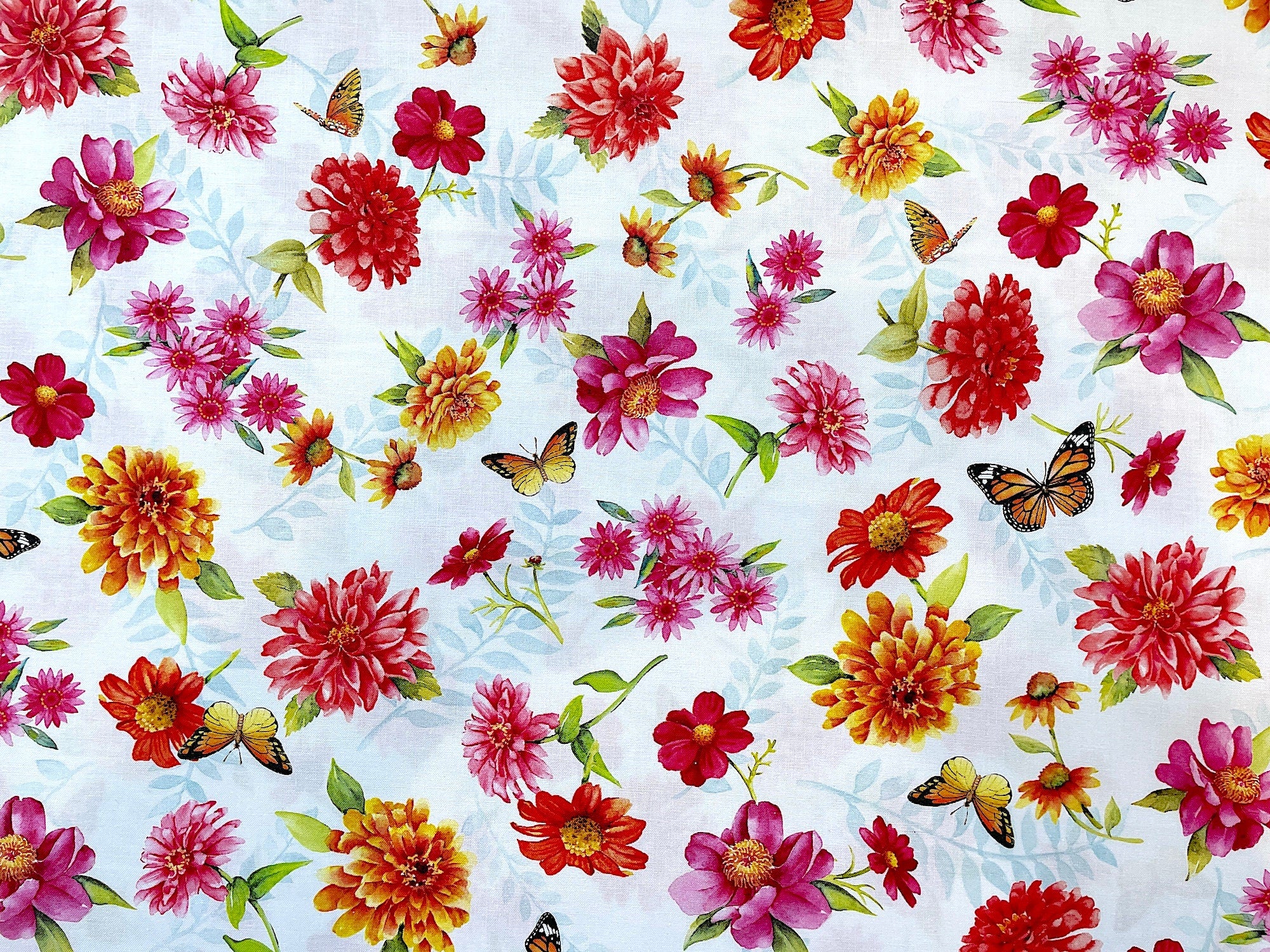 This fabric is called Chinoiserie Garden and it's covered with butterflies and red, pink and yellow flowers and light green leaves