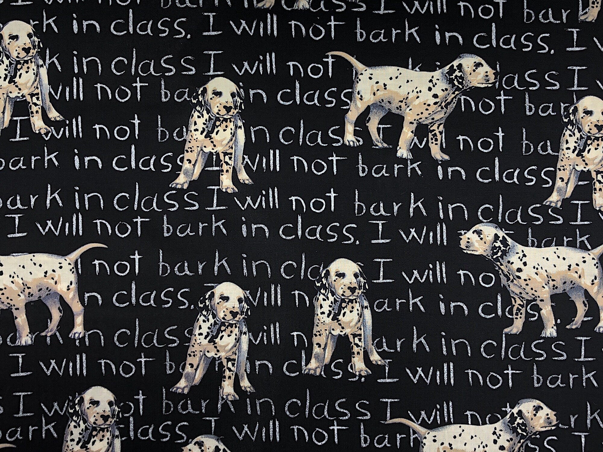 Black cotton fabric covered with Dalmatians and  the saying I will not bark in class.