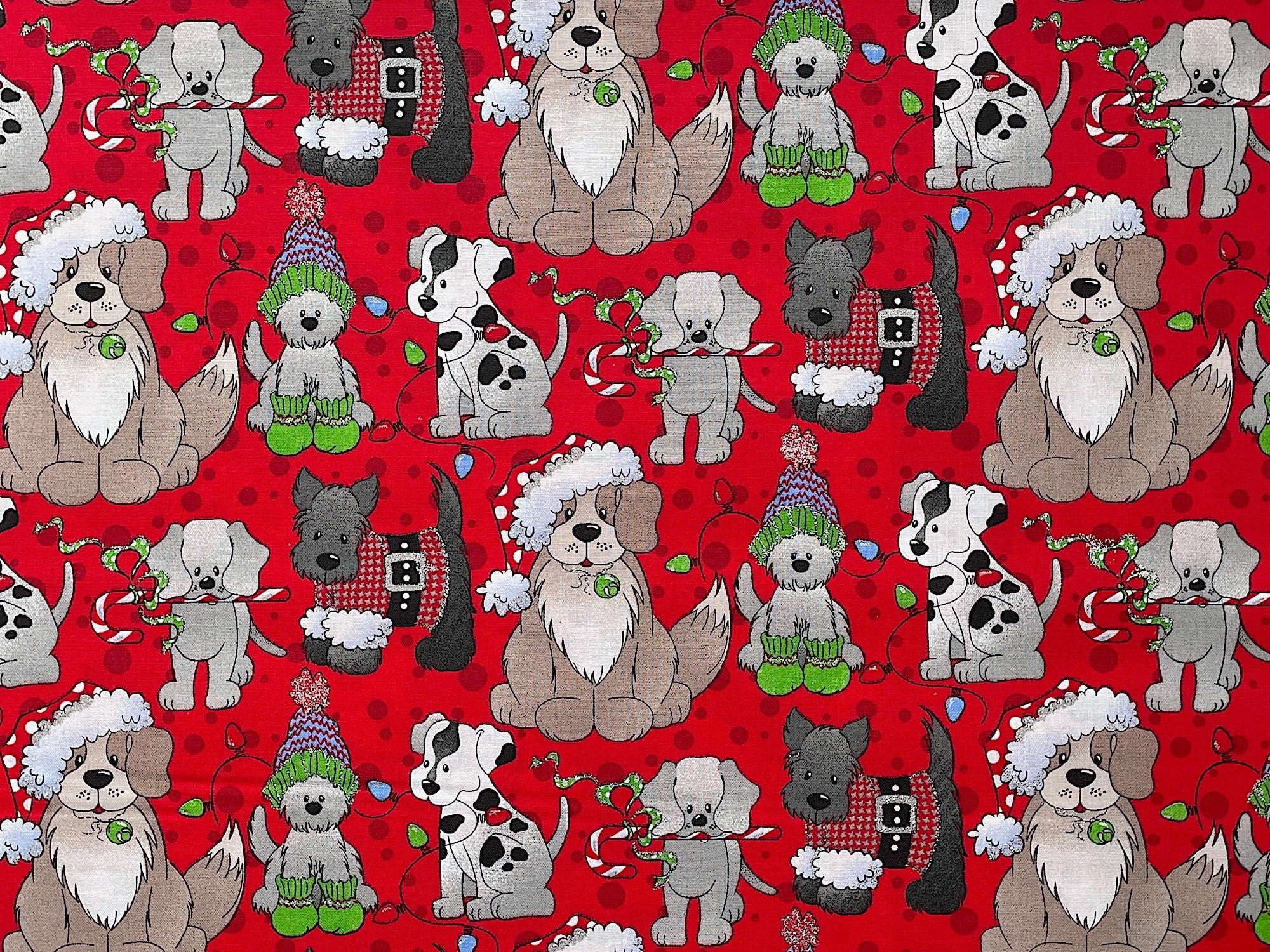 Here is an adorable Christmas themed dog fabric. It has cute small and large dogs with some wearing Xmas hats and holding a string of Christmas lights in their mouth. The Scottie dog wearing a red and gray check sweater, and the gray puppy has a candy cane in his mouth.