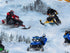 Close up of people riding snowmobiles in the snow.