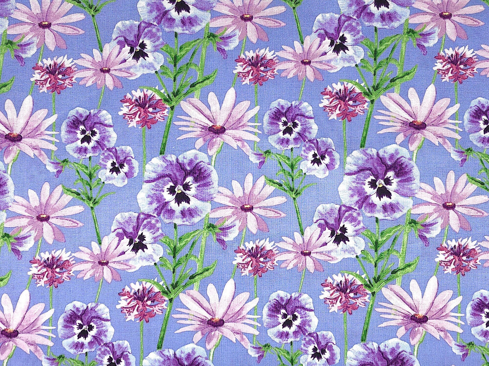 This flower fabric is covered with lavender and purple pansies and pink flowers