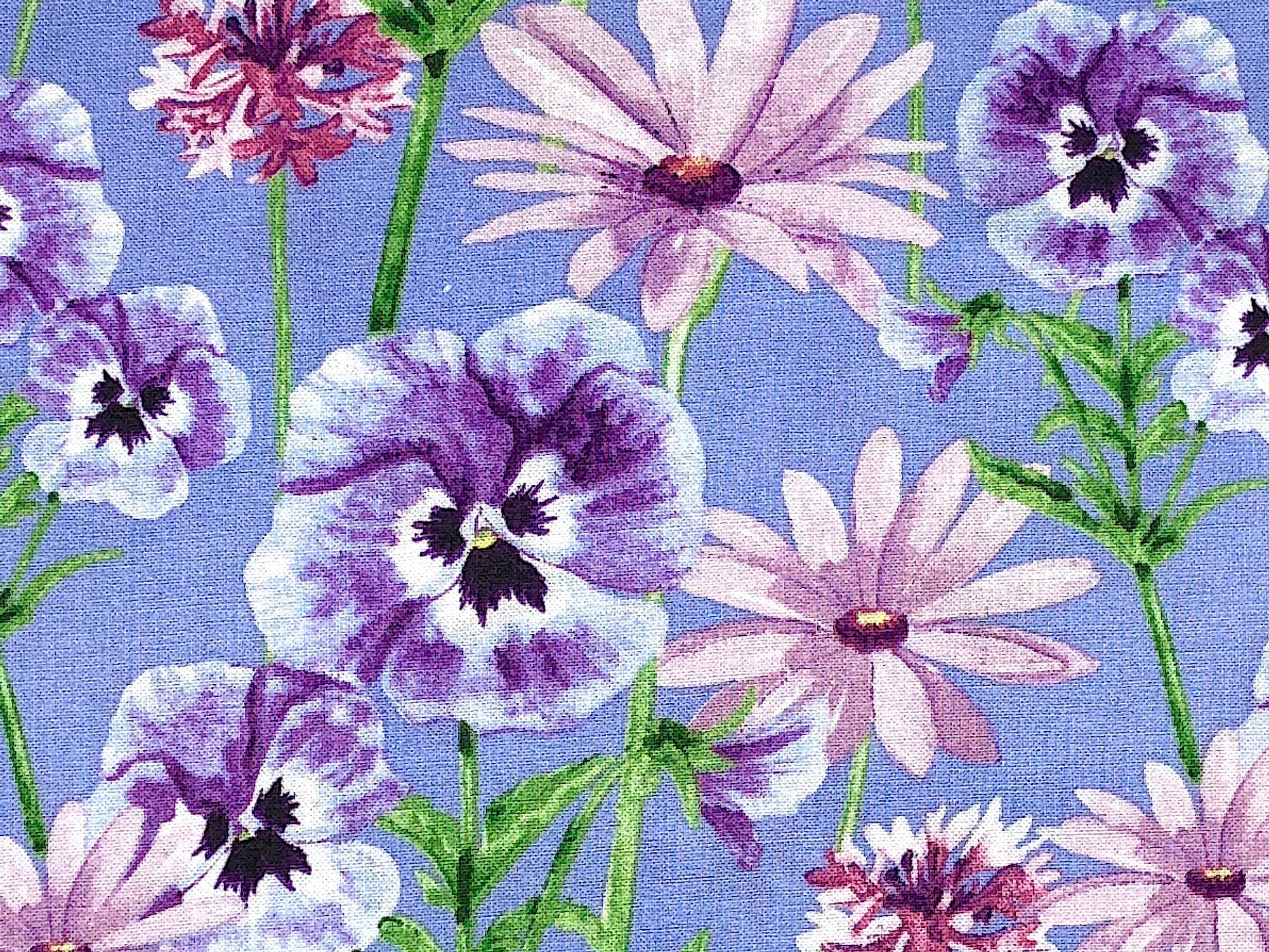 Close up of lavender cotton fabric with purple and white pansies.