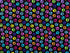 Blue, green, yellow purple, pink and orange paw prints on a black background.