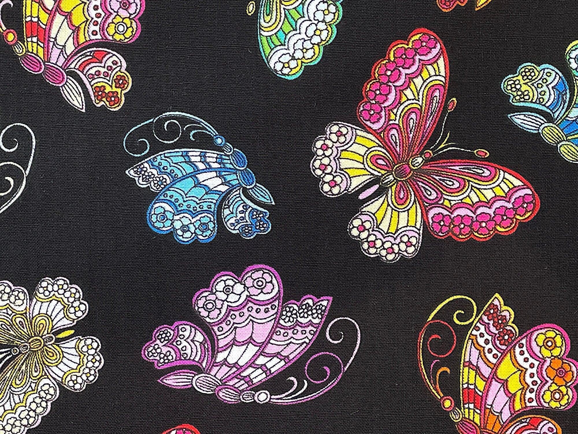 Close up of pink, yellow, purple and blue butterflies.