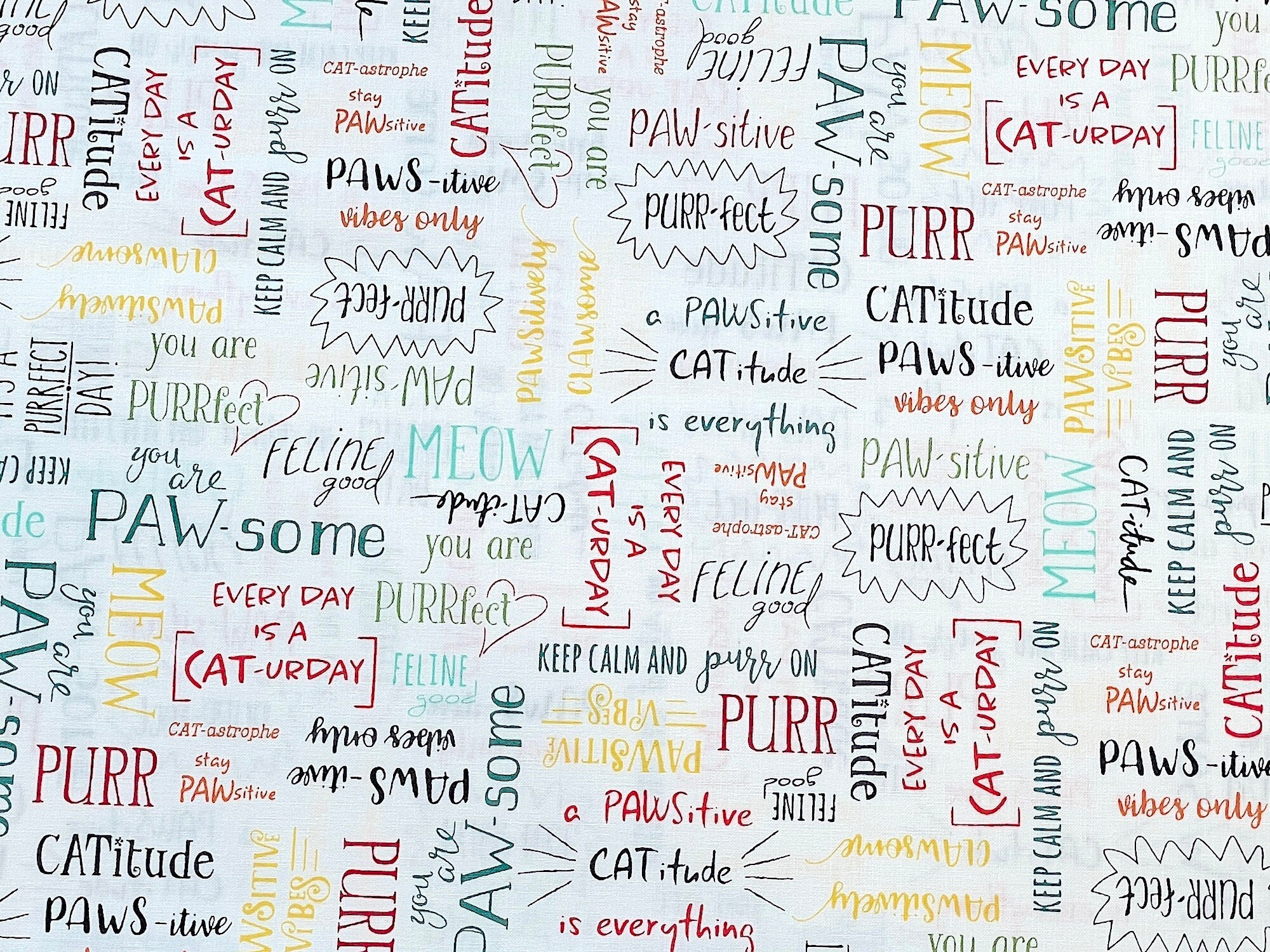 Cat sayings cover this off-white/light cream fabric. Some of the sayings include meow, purr, It's a purrfect day, everyday is a cat-urday and more.