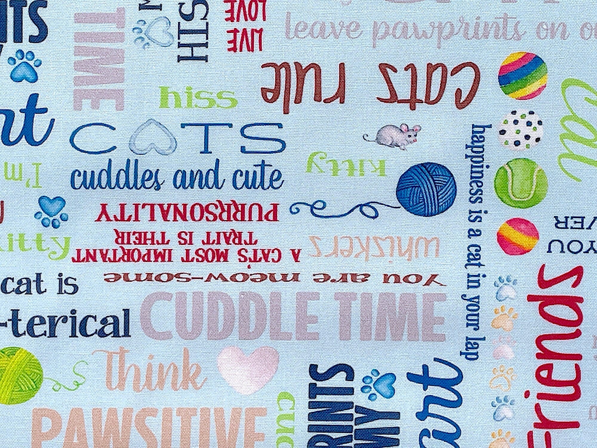 Close up of sayings such as cats rule, cuddles and cute, cuddle time and more.