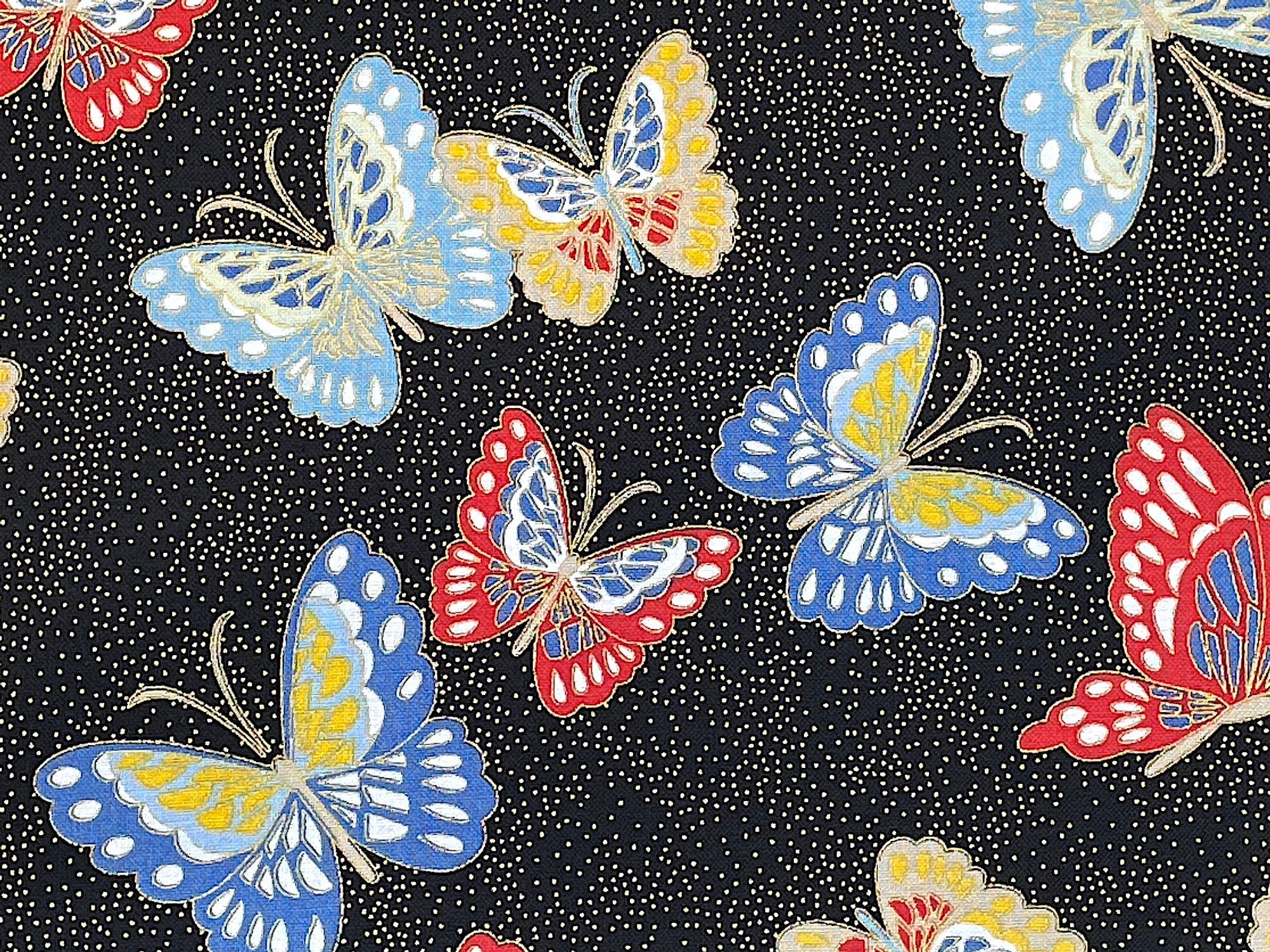 Close up of butterflies that are blue, yellow, white and red.