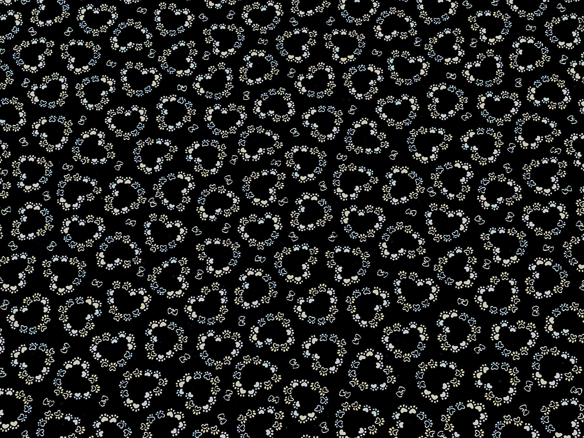 This black fabric is covered with paw prints in a heart shape
