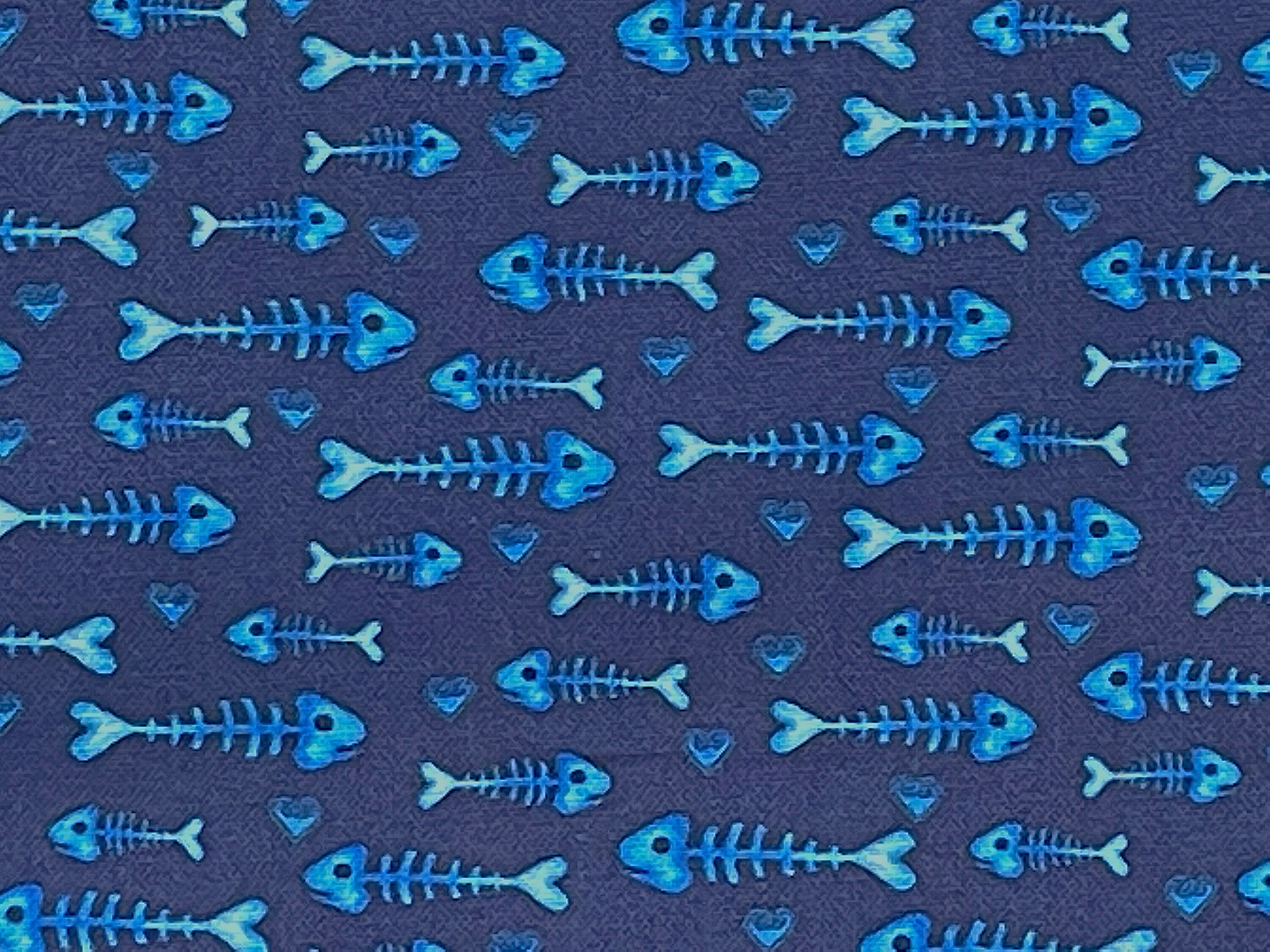 This blue fabric is covered with fish bones. This fabric is part of the Kitty City collection by Andi Metz.