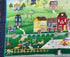 Close up of part of the panel which includes cats, buildings, fence, kitty flag, flowers and more.