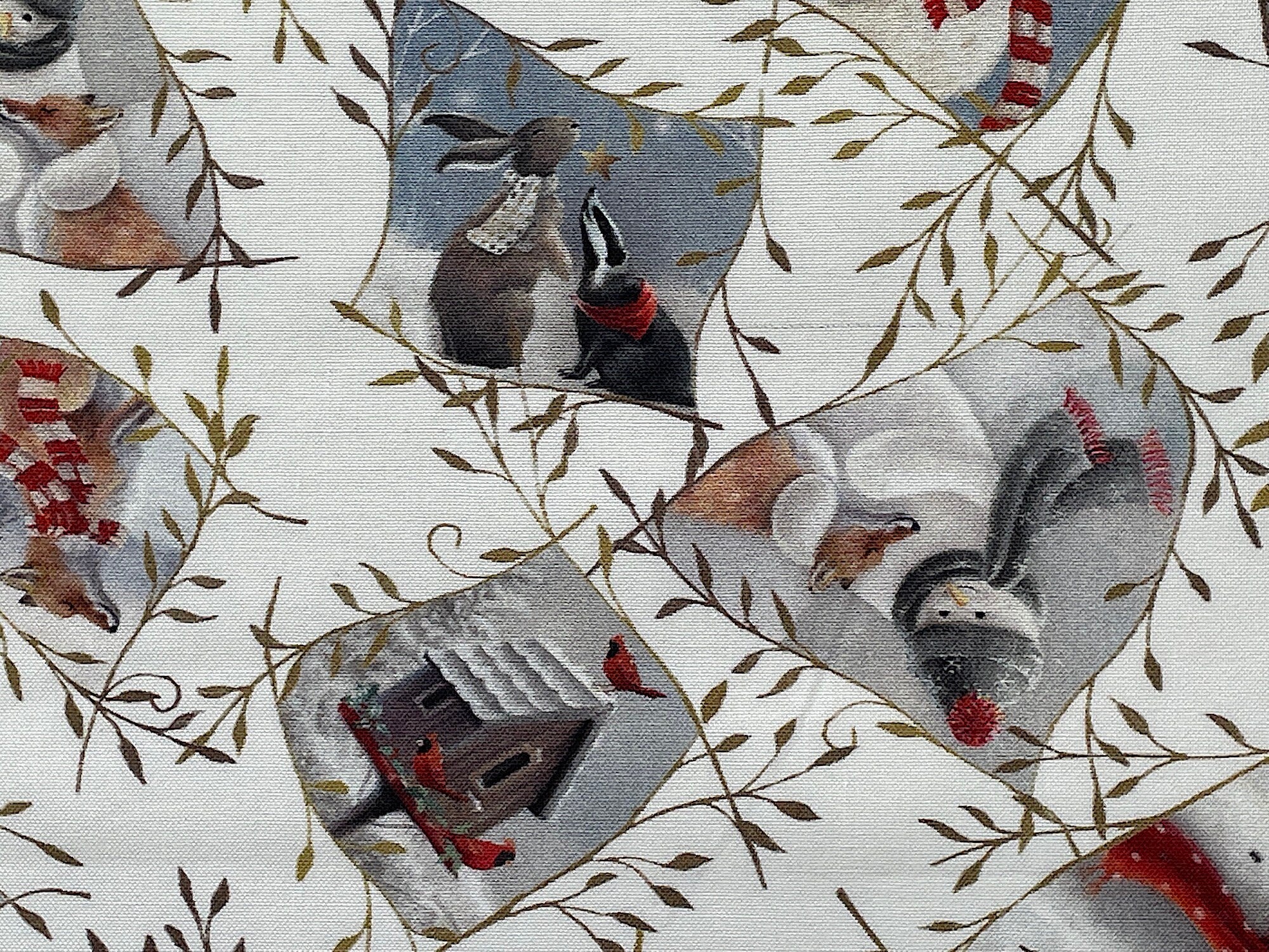 This white fabric is covered with snowmen, bird houses, birds and other wildlife such as bears, bunnies and fox.